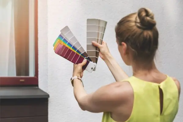 woman choosing paint color for house ecterior facade