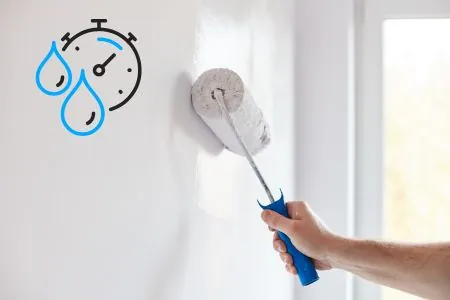 male hand painting wall with paint roller